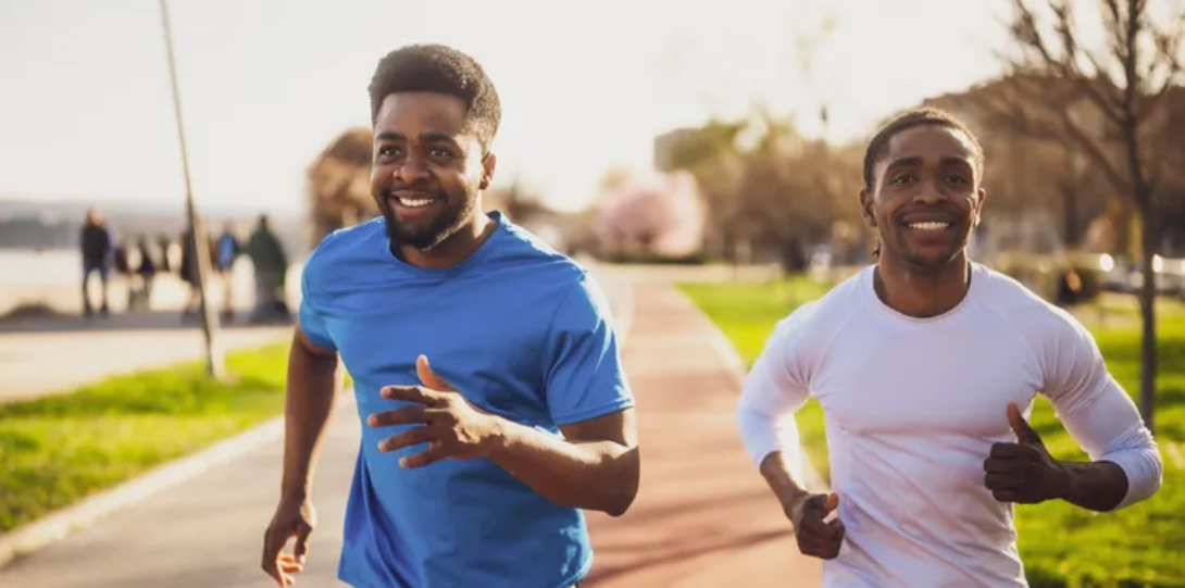 two black men running with smiles
